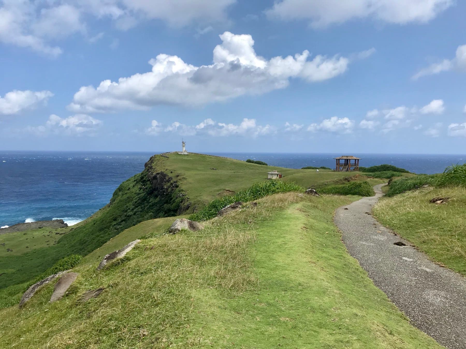A footpath follows the grassy spine of Agarizaki toward the lookout at the end of the cape with open ocean on both sides.