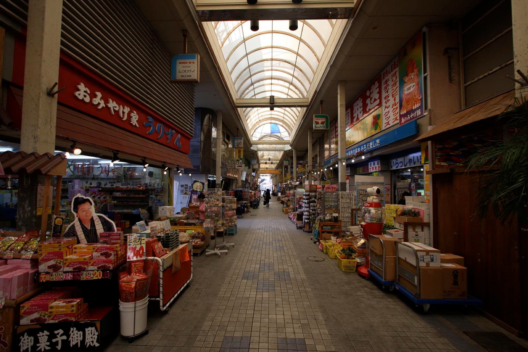 Souvenir stalls stacked with sweets and snacks line both sides of the covered Euglena Mall arcade in central Ishigaki.