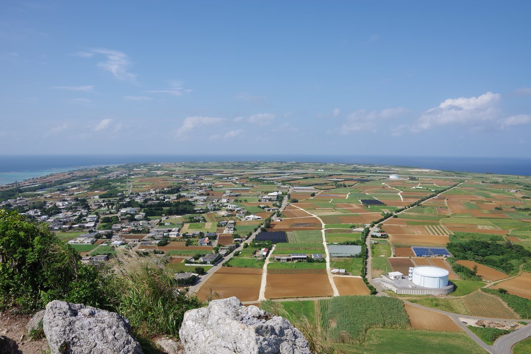 From the summit of Gusuku-yama a patchwork of fields, farm roads and low houses spreads flat across Ie-jima to the sea on every side