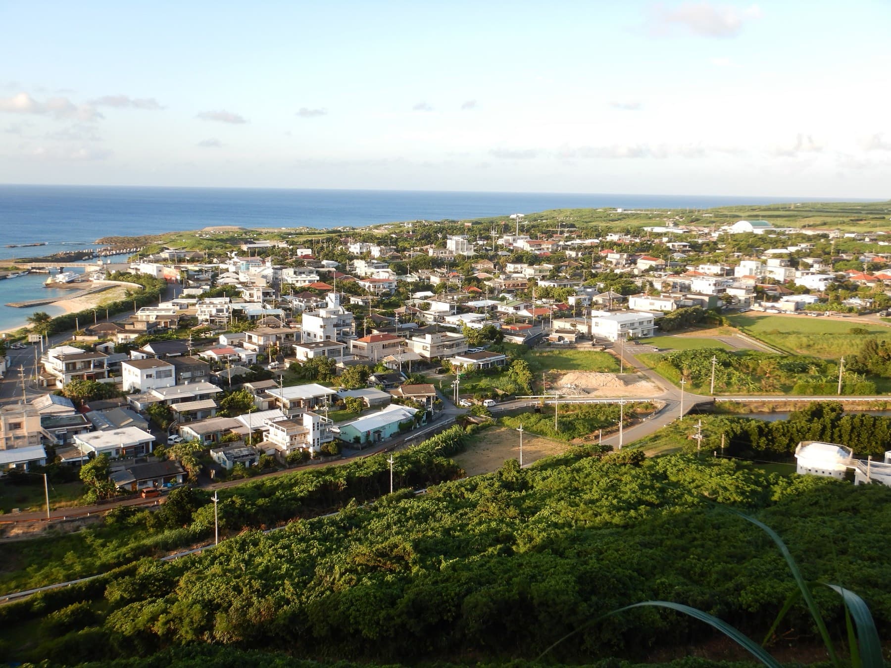 The low houses of Sonai spread to the harbour and the sea below the lookout on top of Tindabana.